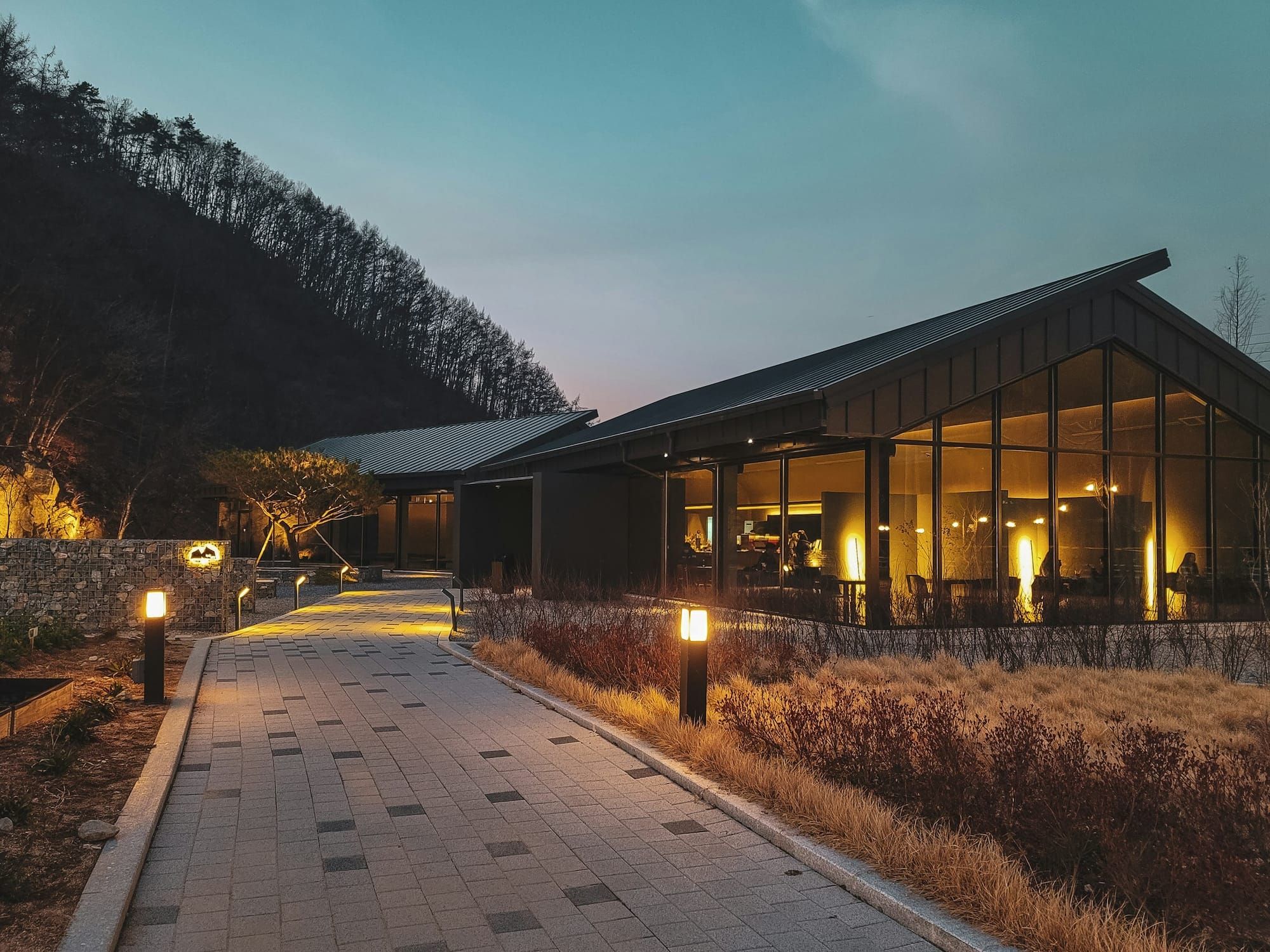 A waterfront event venue set with long banquet tables